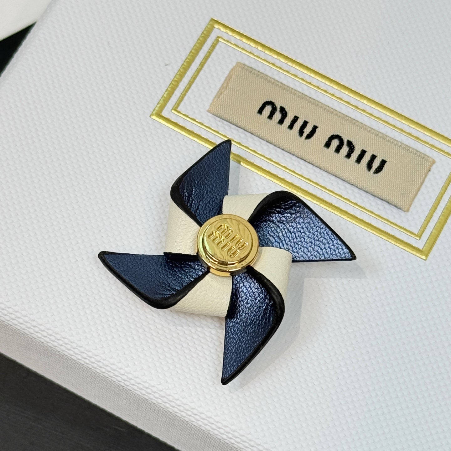 Leather pinwheel brooch