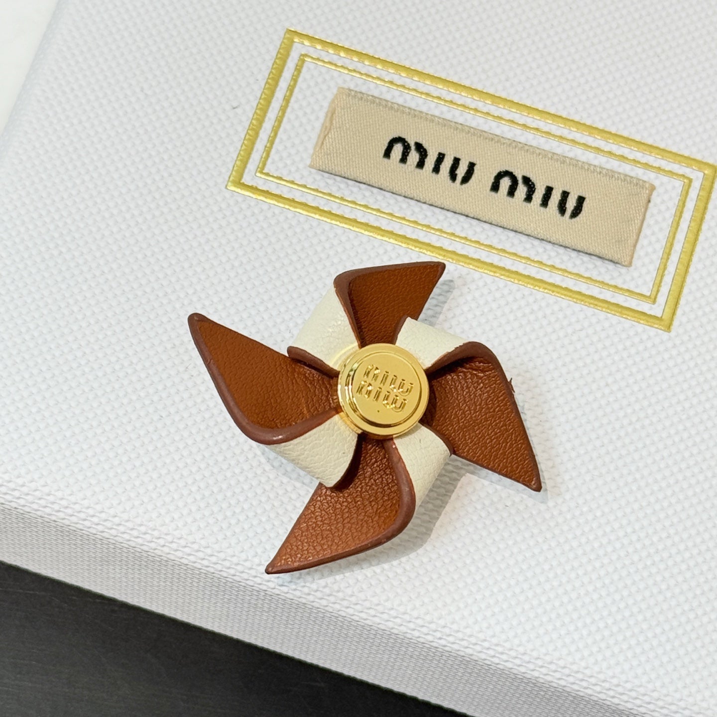 Leather pinwheel brooch